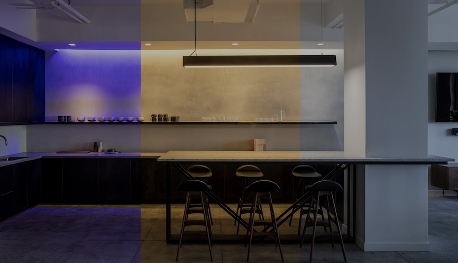 A bar space lit up with different colours with Ketra lighting.