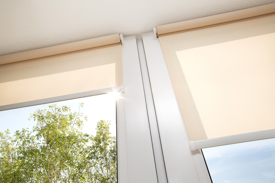Image is of a pair of motorized shades covering the windows in a home.